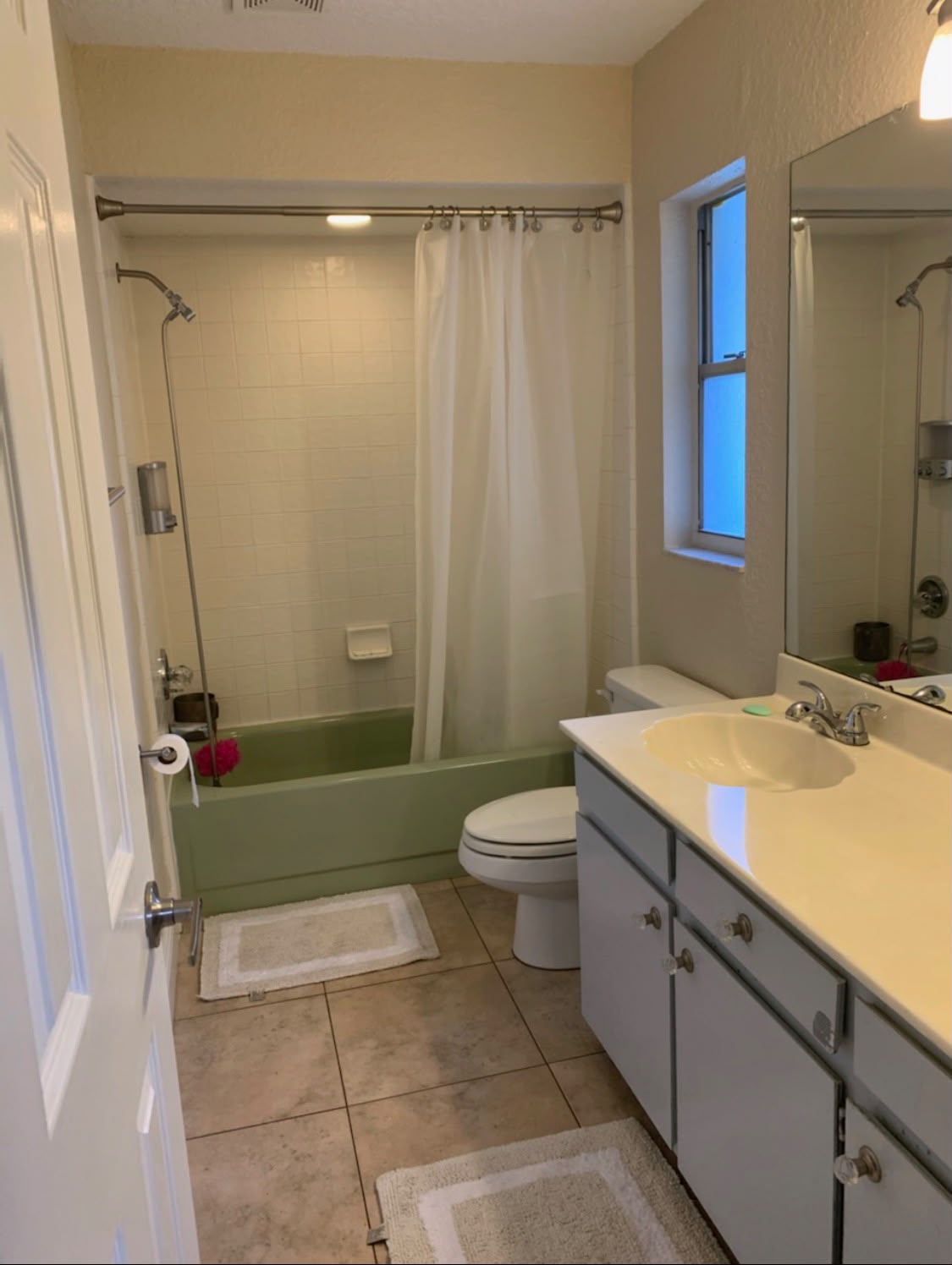Bathroom with old green tub before demolition