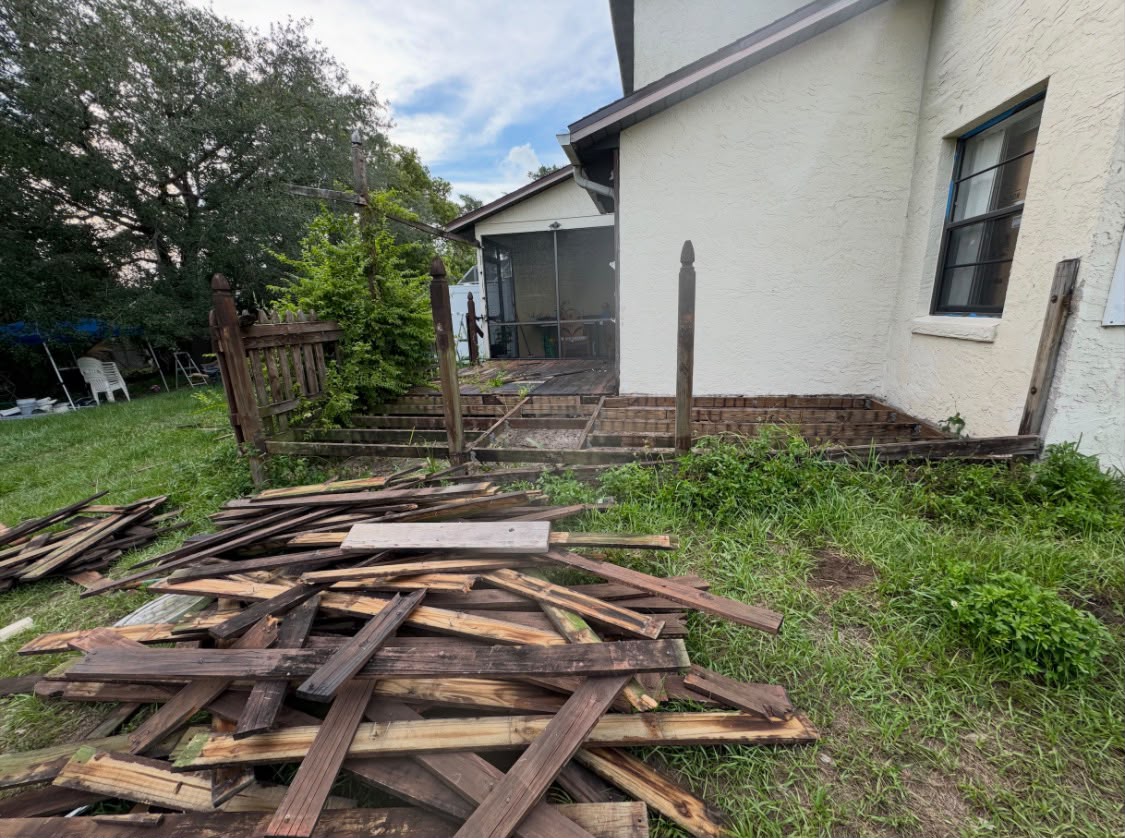 Old wood deck torn down with debris piled up